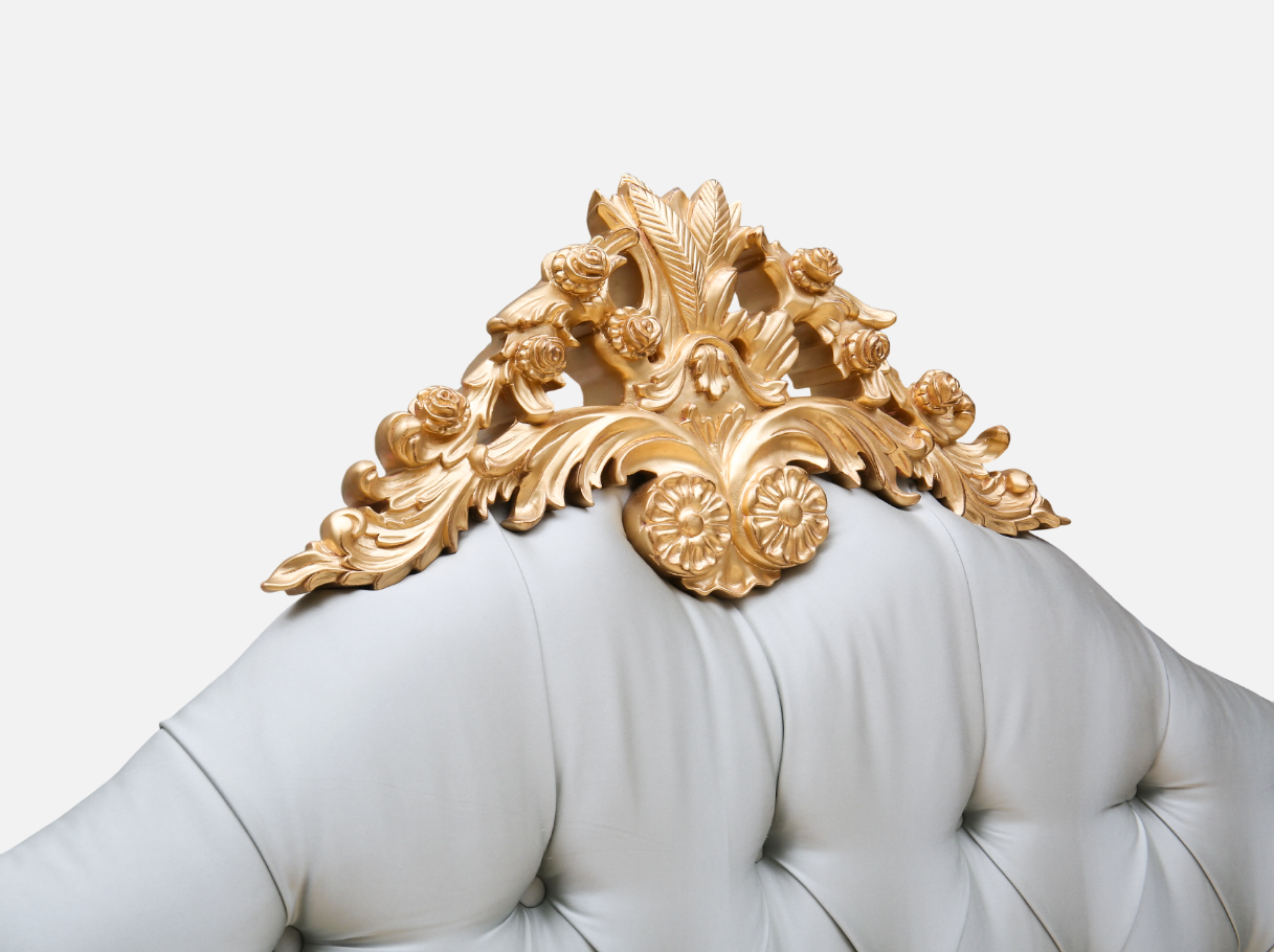 Close-up of B-099 leather bed frame — beech wood carved gold leaf crest, tufted leather headboard, and French Rococo detailing