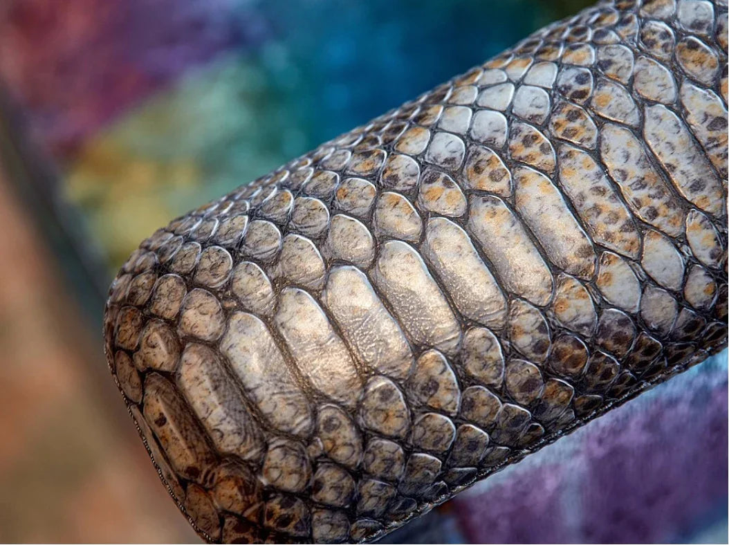 Detailed close-up of snake-embossed leather on luxury art deco armchair