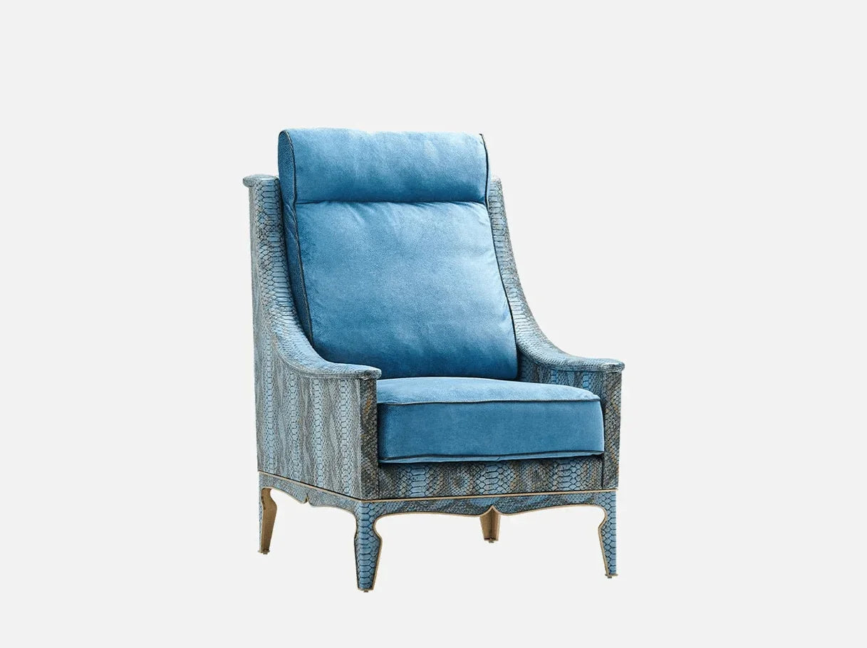 Side angle of MA-579 modern wingback chair showcasing brass-plated structural details and tailored blue silhouette