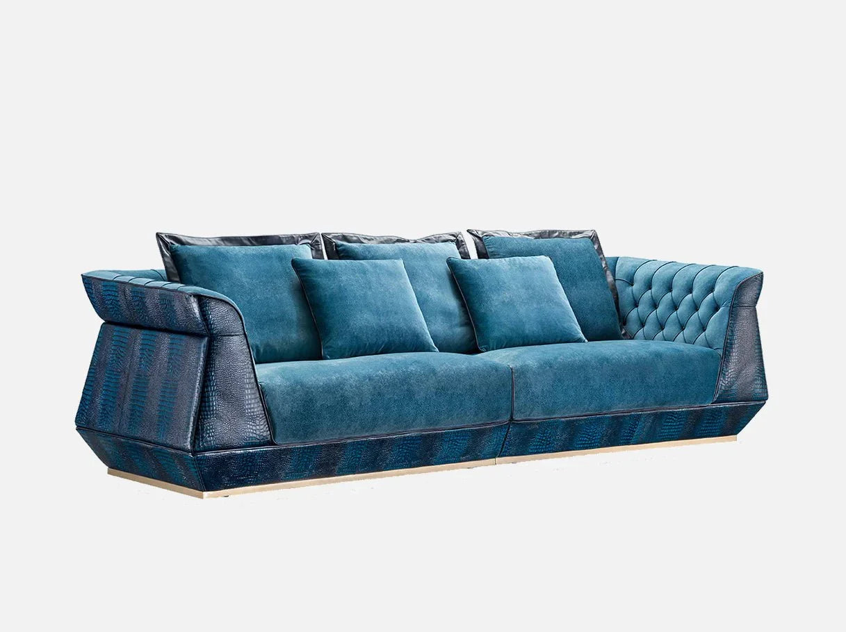 Side angle of MS-2511 blue velvet sofa showcasing 304 stainless steel brass-plated frame details and lush blue velvet upholstery