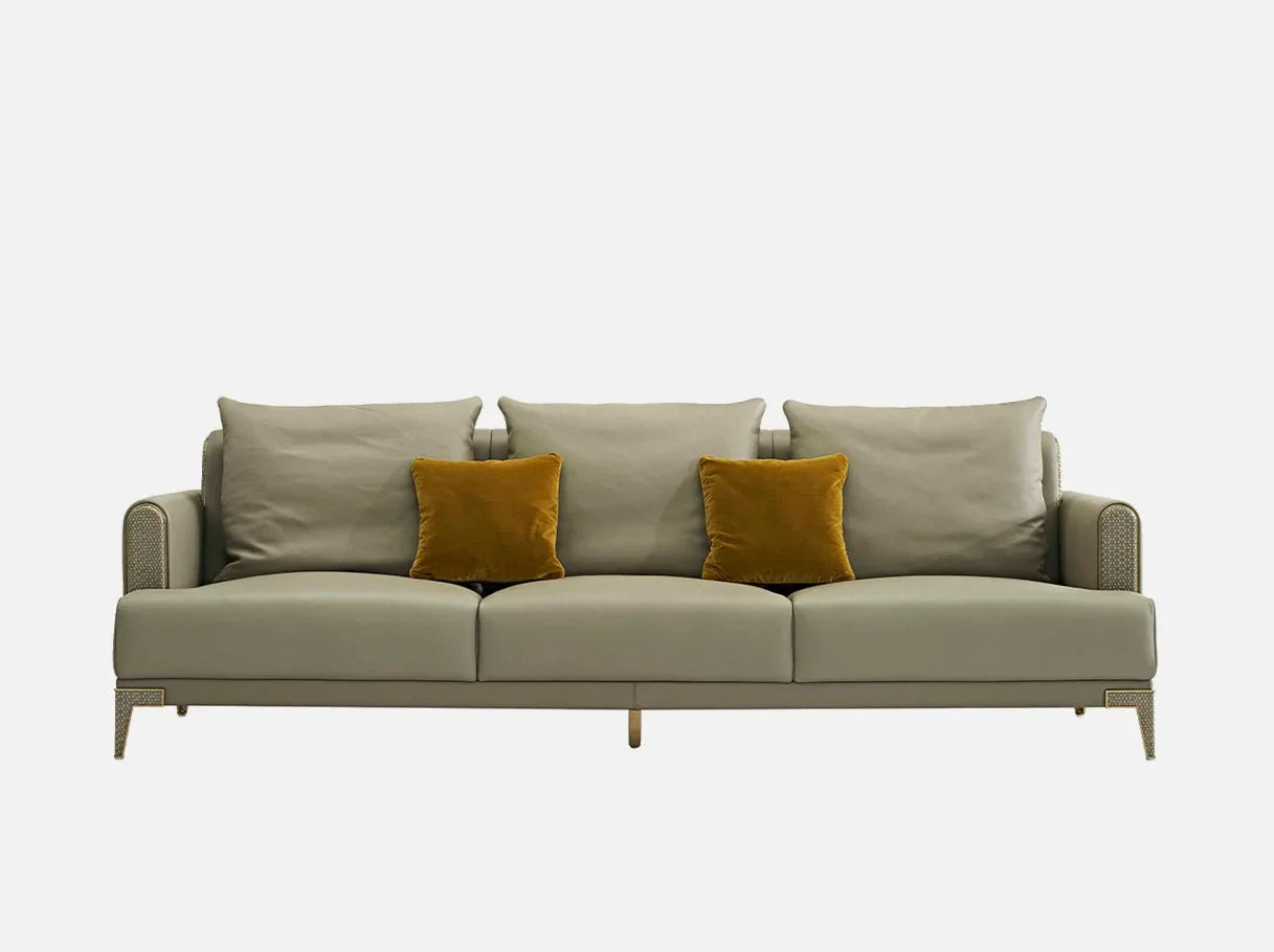 Front view of Art Deco sofa MS-3130 in beige leather with yellow cushions, brushed brass accents, and double-P base.