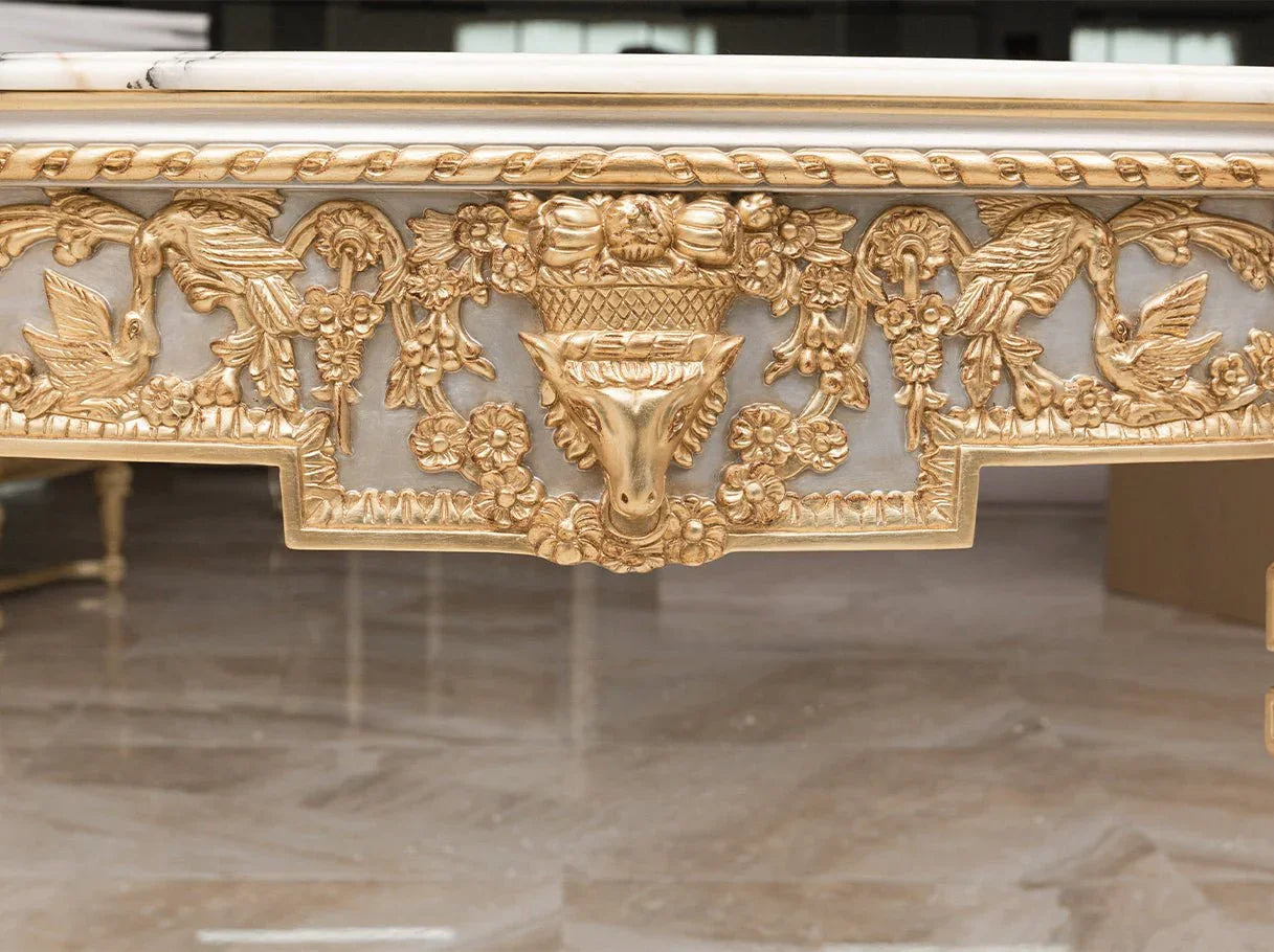 Close-up of apron carvings on gold console table CS-0063, featuring floral garlands and urn motif in gold leaf finish.