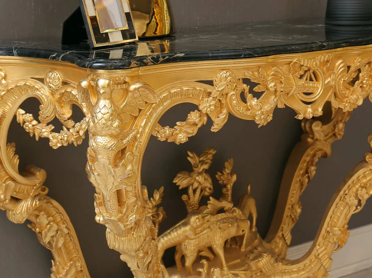 Close-up of retro console table gold leaf carvings and marble top, highlighting craftsmanship for luxury furniture and timeless home design.