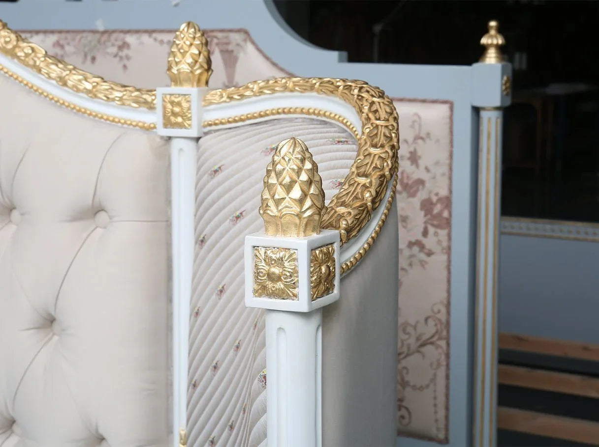 Close-up of B-041 French bed carved beechwood frame with gold leaf accents and floral decorative motifs.