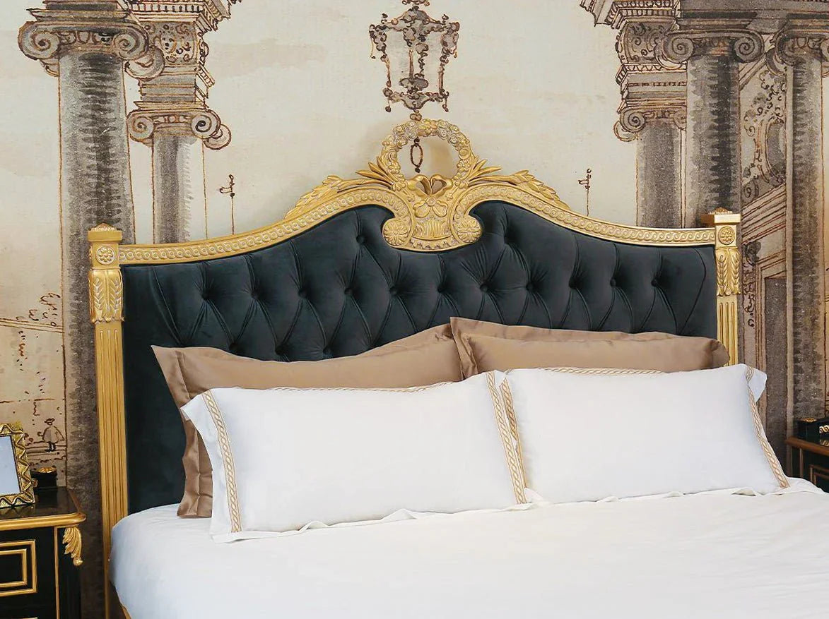 Close-up of button-tufted velvet headboard on French style bed B-077 with gold accents.