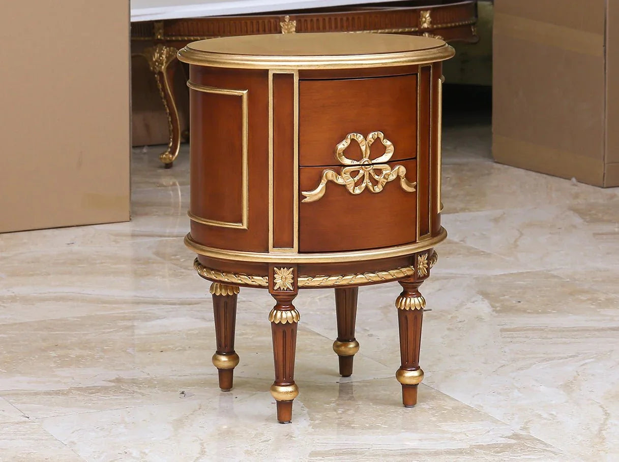 Luxury round nightstand with carved drawer handles in gold leaf