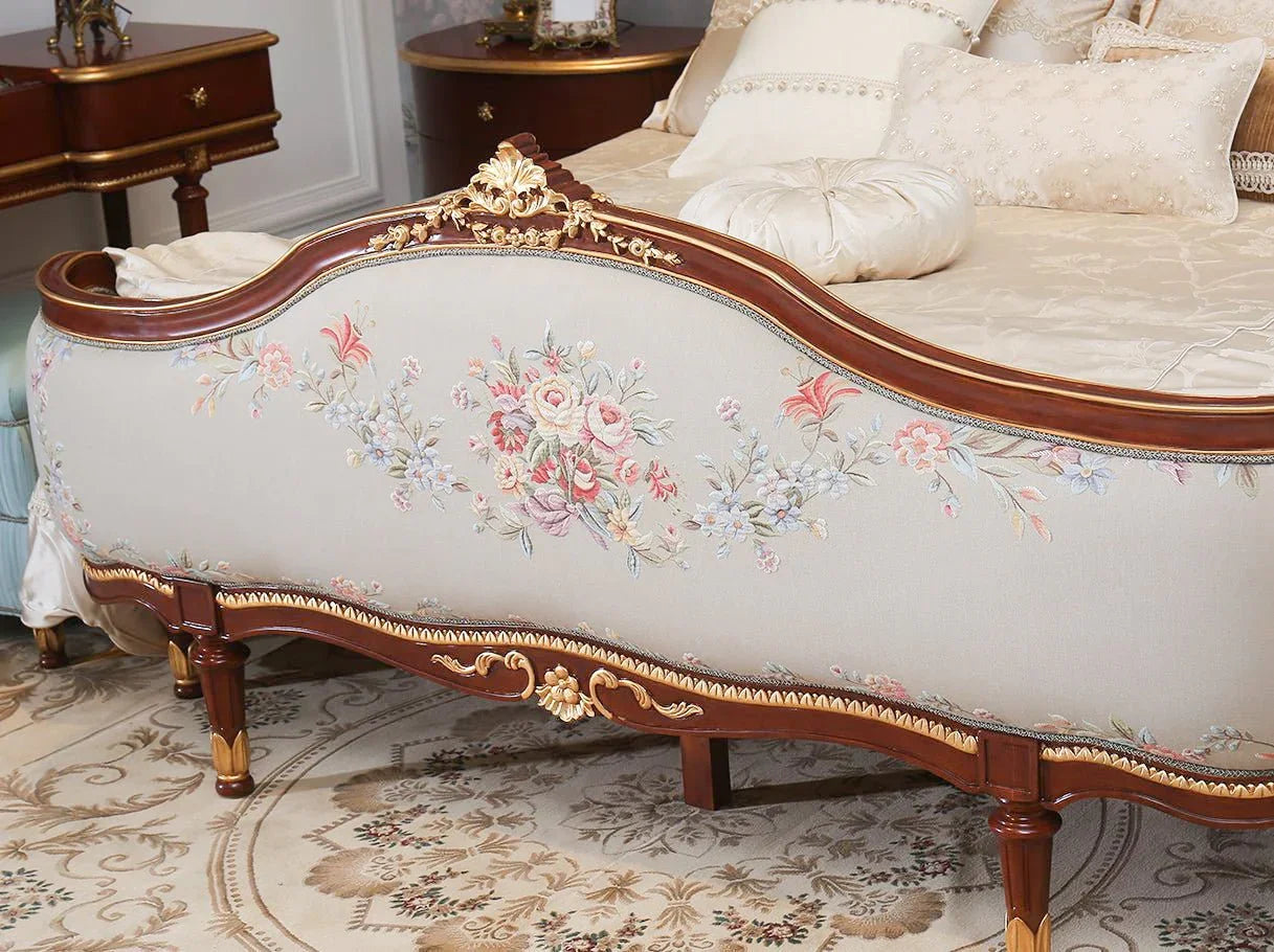 Close-up of B-082 footboard with floral jacquard and carved wooden frame.