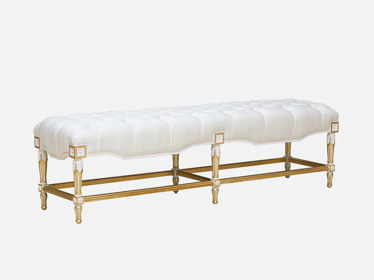 Luxury white upholstered bench for bedroom interiors with carved gold frame