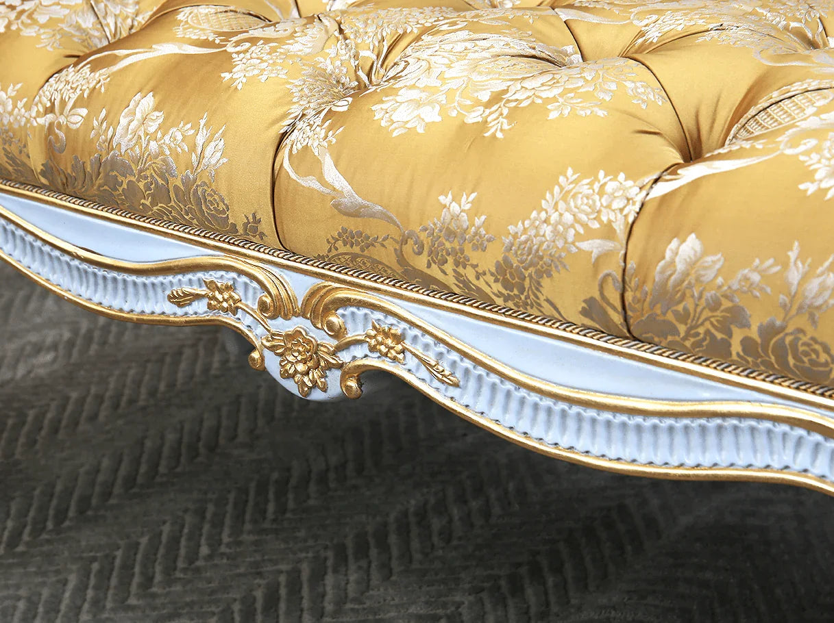 Close-up of tufted jacquard fabric and gold leaf carving on bedroom bench seat
