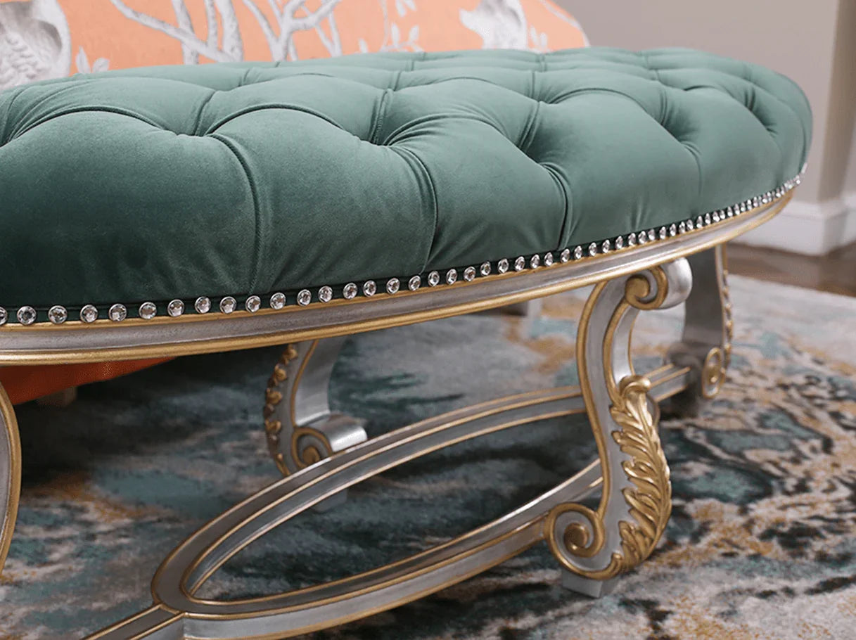 French bedroom bench with carved details, curved legs, and tufted upholstery