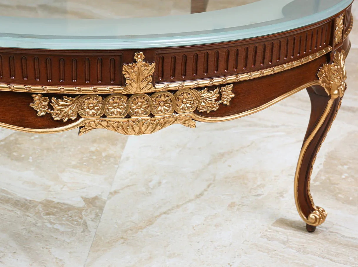 Close-up of the glass coffee table CT-0506 reveals hand-carved details and gold leaf accents, reflecting artistry in high end furniture.