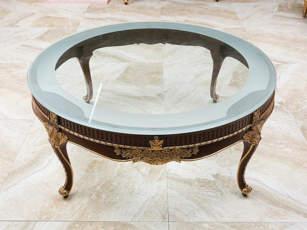 The oval glass coffee table CT-0506 highlights a clear surface and ornate carvings, making it a timeless choice for luxury living rooms.