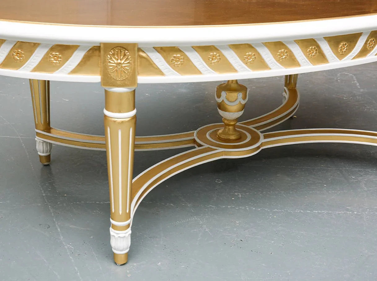 Close-up of CT-0087 oval coffee table details reveals hand-carved motifs with radiant gold leaf finish for luxury home furnishing.