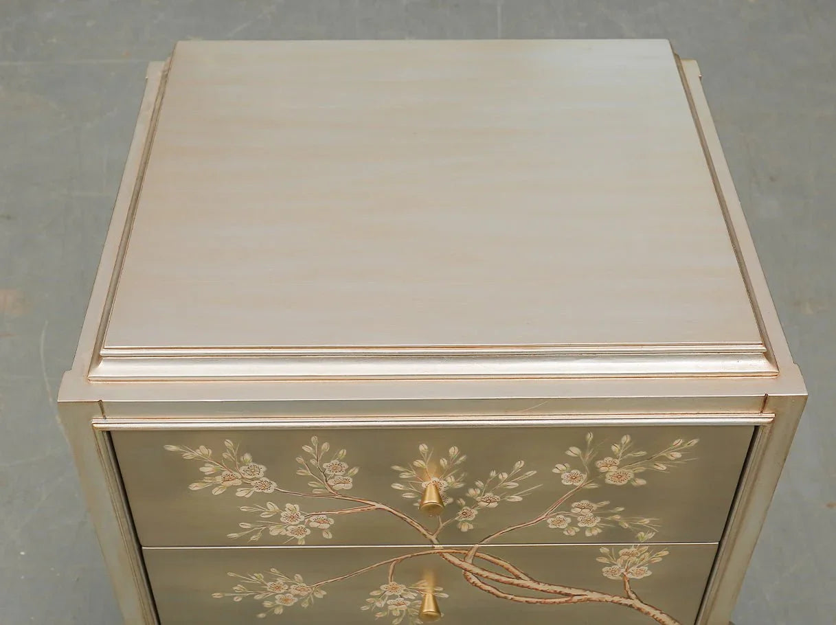 Elegant silver bedside table with curved design and hand-painted accents