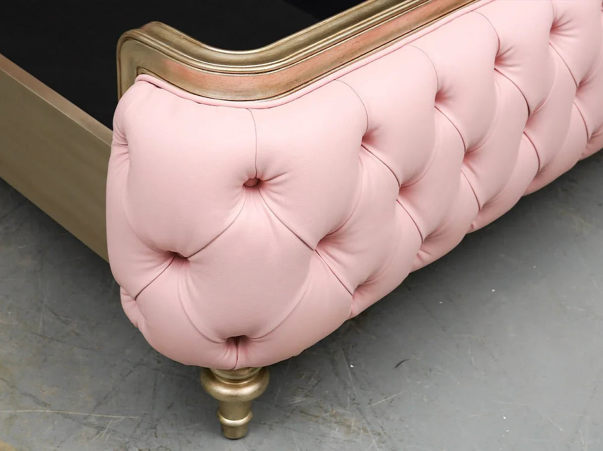 Footboard detail of luxury leather bed B-361 with soft tufted upholstery and carved accents.