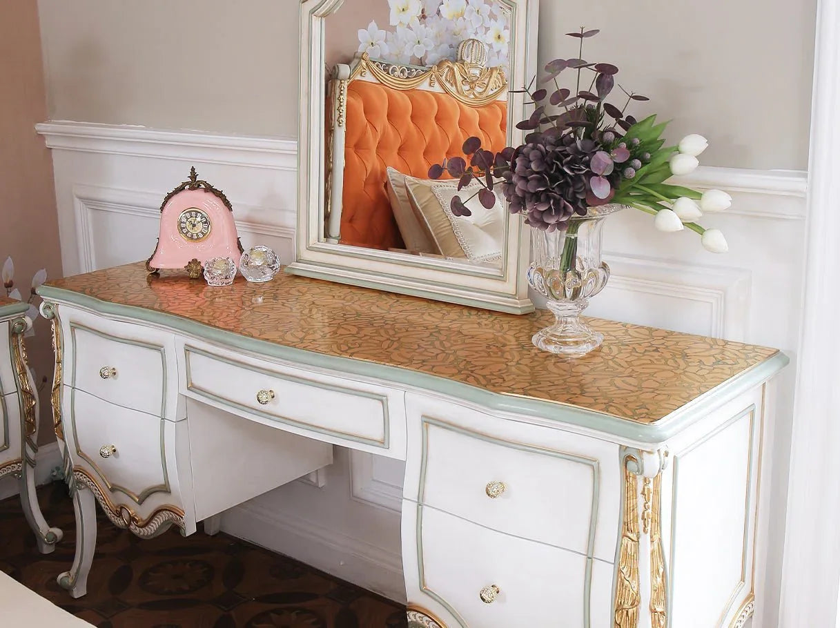 French style vanity dresser with matching mirror and stool in luxury bedroom setting.