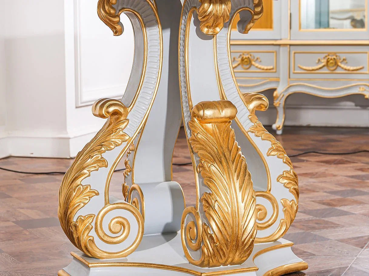 D-085 dining table pedestal base detail: Intricate hand-carving, gold leaf embellishments on curved wood – highlights craftsmanship.