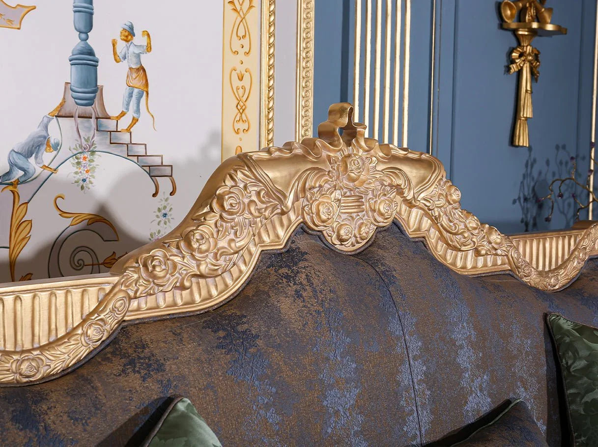 Ornate crest detail of French sofa S-1003 with intricate scroll carving, gold leaf highlights, and blue jacquard upholstery.
