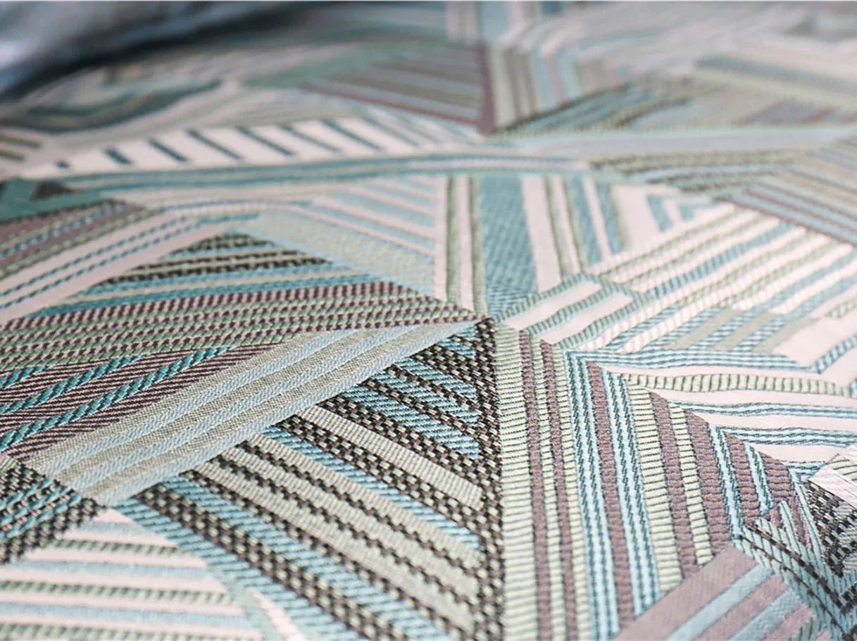 Jacquard fabric detail of French sofa S-1124 showing layered geometric patterns with sheen.