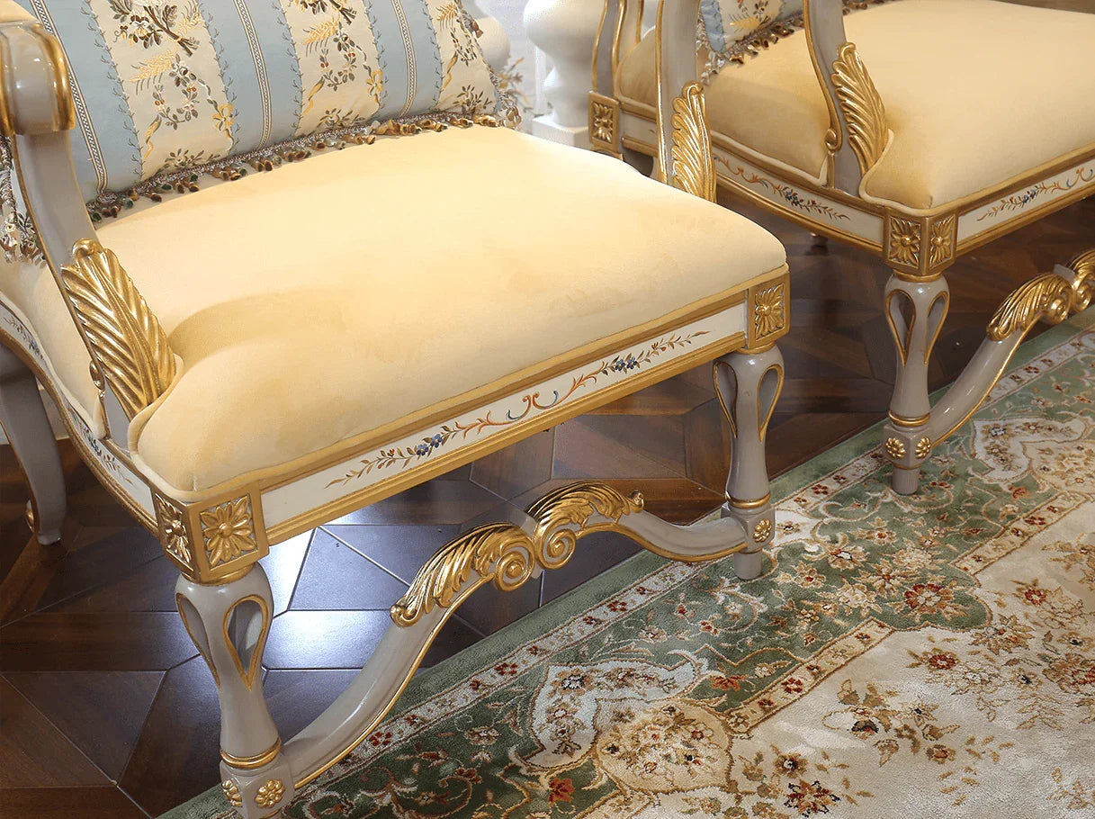 Carved front-leg detail of French armchair A-0349 with hand-painted floral motifs and gold leaf highlights.
