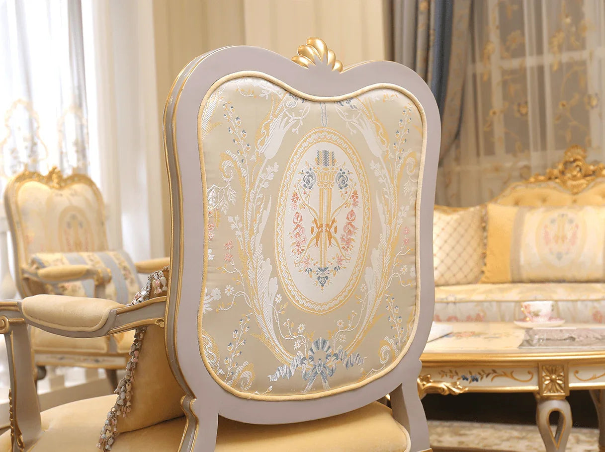 Backrest detail of French armchair A-0349 showcasing floral jacquard pattern and gold leaf carvings.