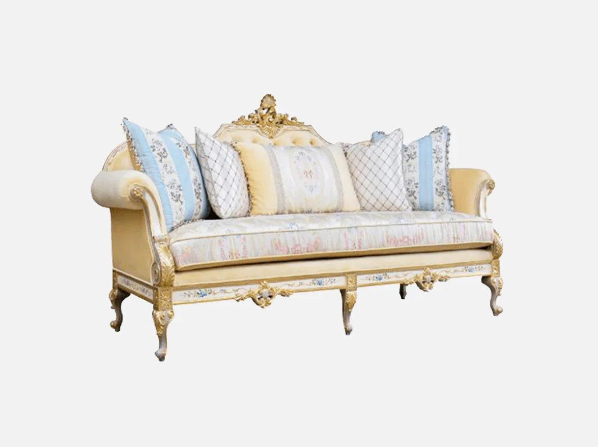 Side view of French sofa S-1138 highlighting its carved beech wood frame, curved arms, and layered decorative cushions.