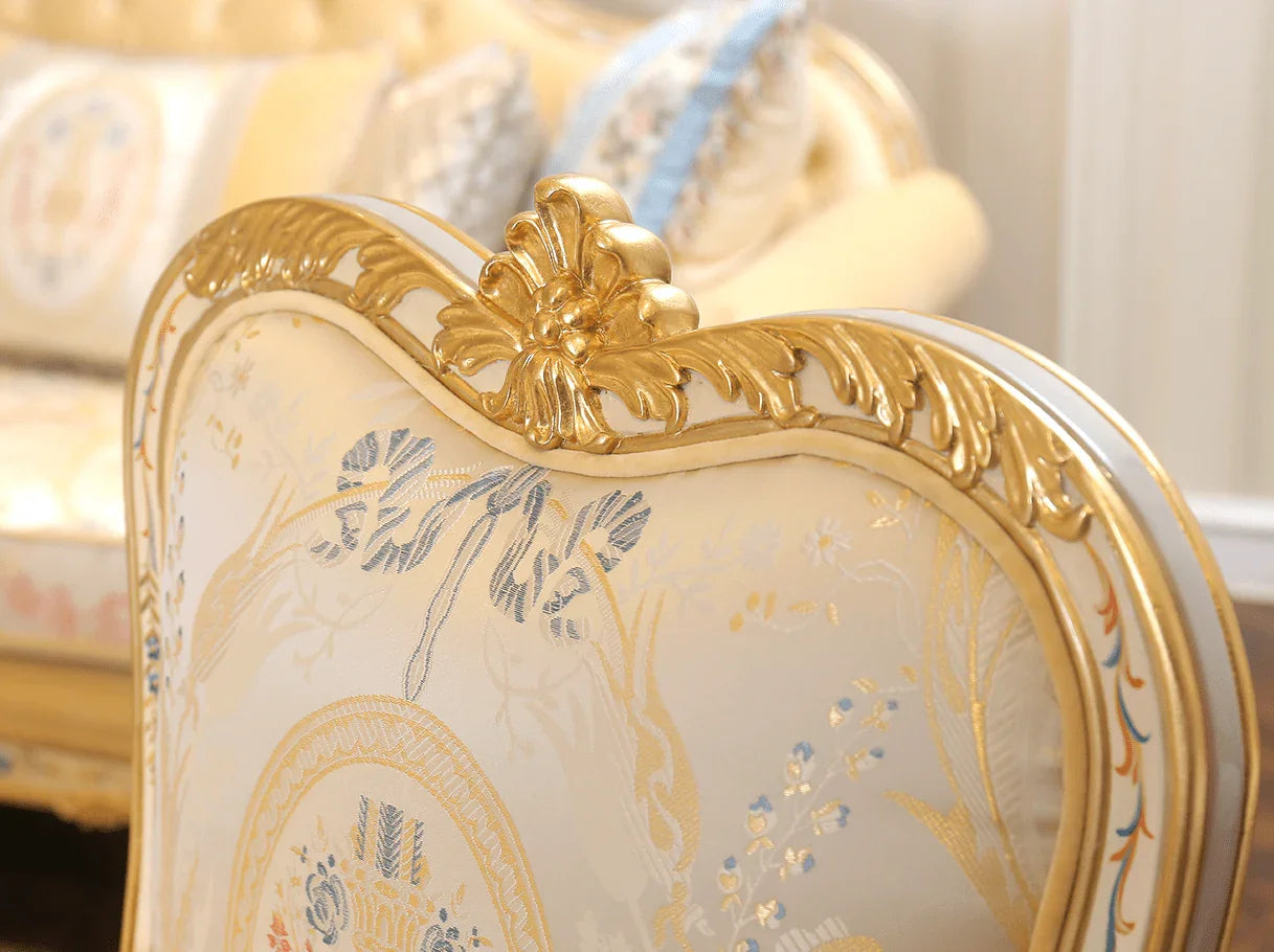 Crest carving detail of French armchair A-0349 with gold leaf finish and ornate floral motif.