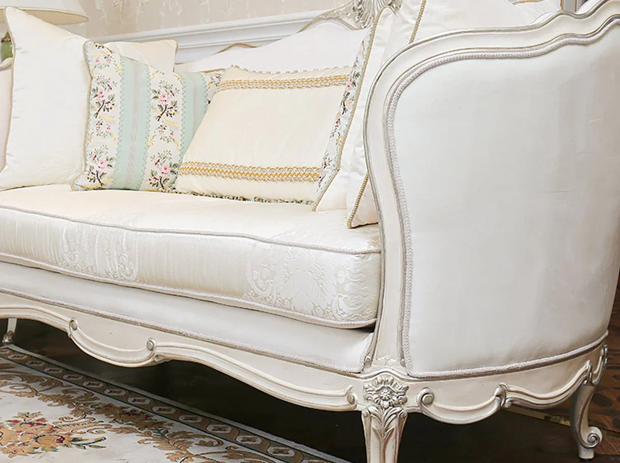 Armrest and leg detail of French sofa S-1169 featuring hand-carved beech wood with silver leaf highlights and jacquard upholstery.