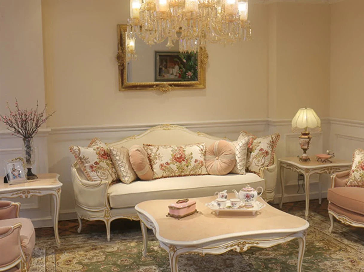 French style living room furniture set with a luxury French sofa, armchairs, side tables, and a coffee table in soft white and pink tones.
