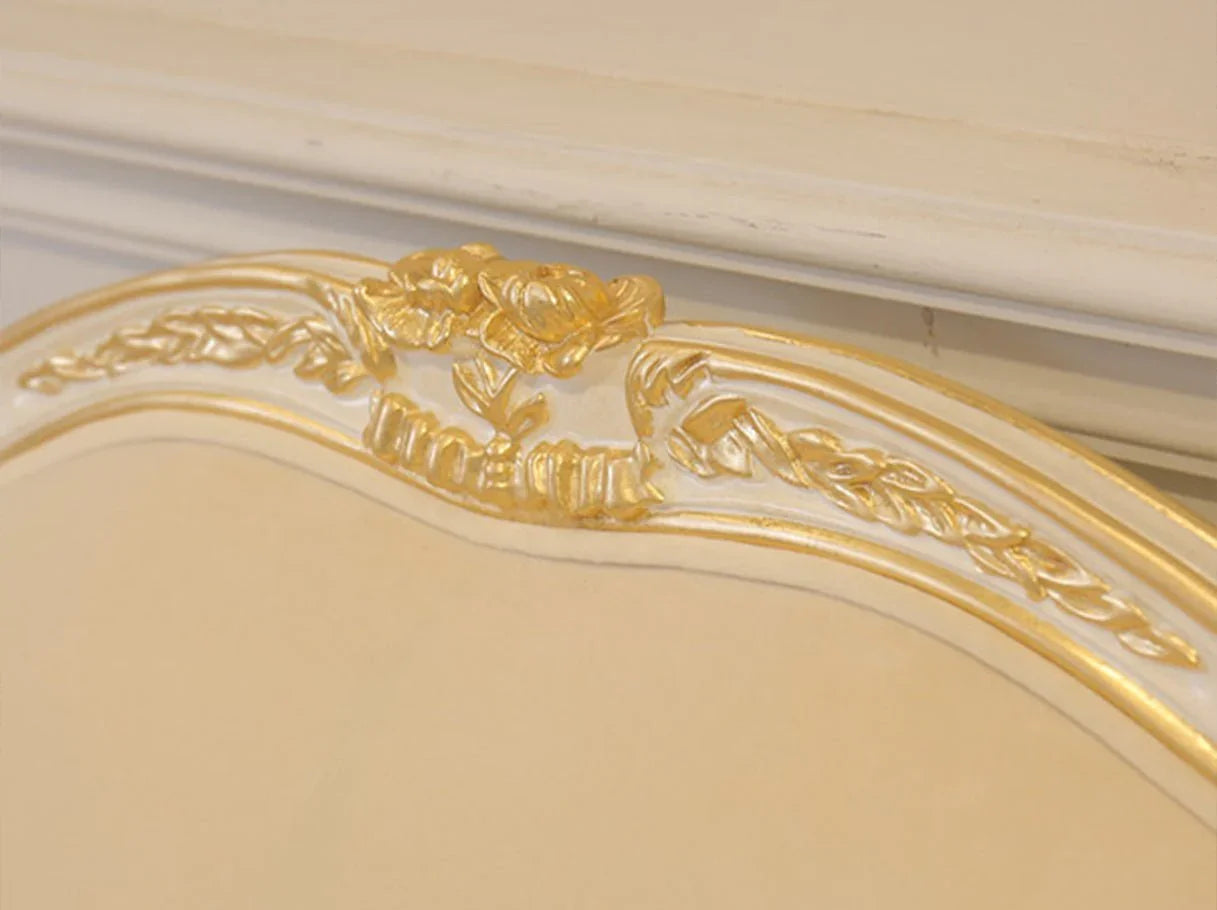 Close-up of French sofa S-1171 frame with ornate hand-carved beech wood and shimmering gold leaf craftsmanship.