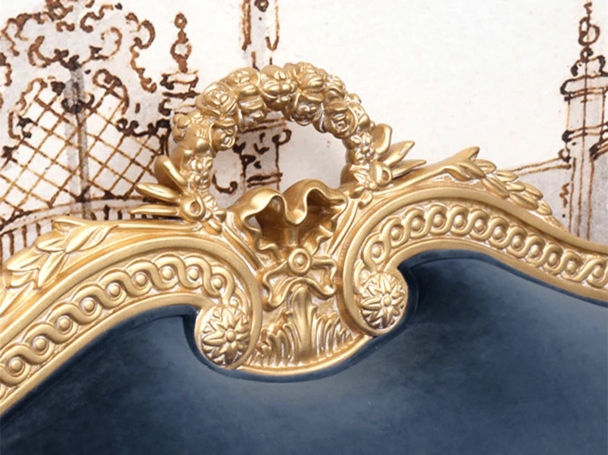 Close-up of ornate carved crest on French sofa S-1178 3-seater with gold leaf detailing and navy velvet backrest.