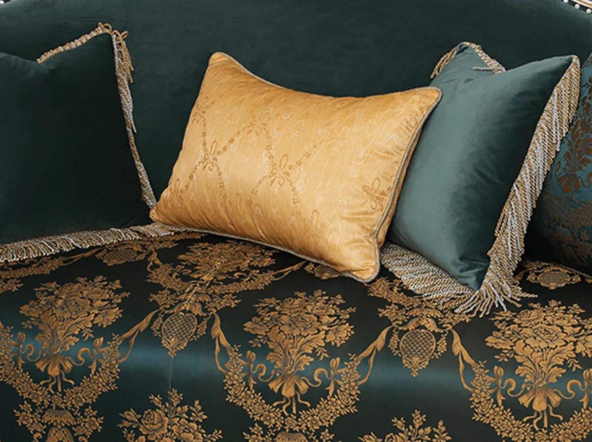 Close-up of decorative pillows on French sofa S-1186 3-seater, combining gold jacquard and green velvet with fringed edges.