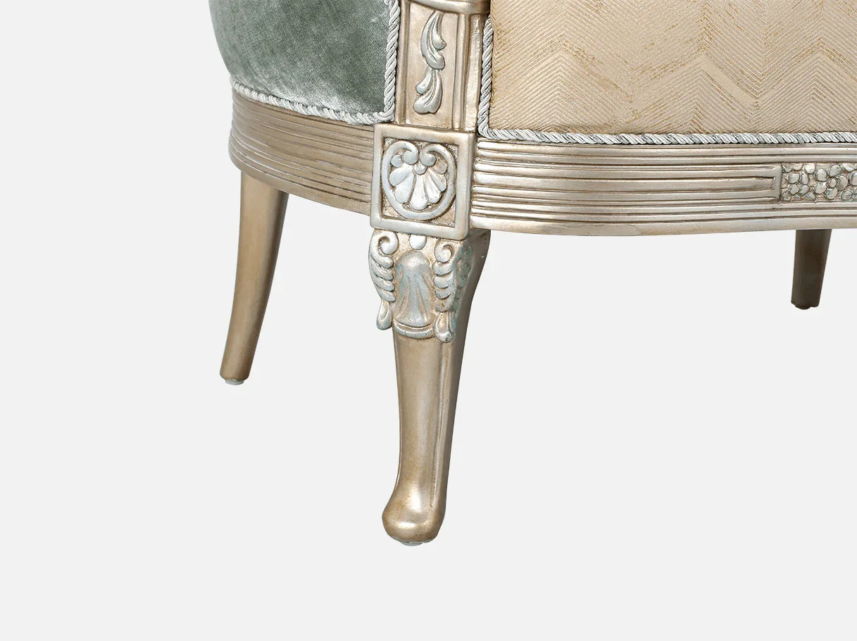 Carved crest detail of French armchair A-1192 with silver leaf highlights on beech wood frame.