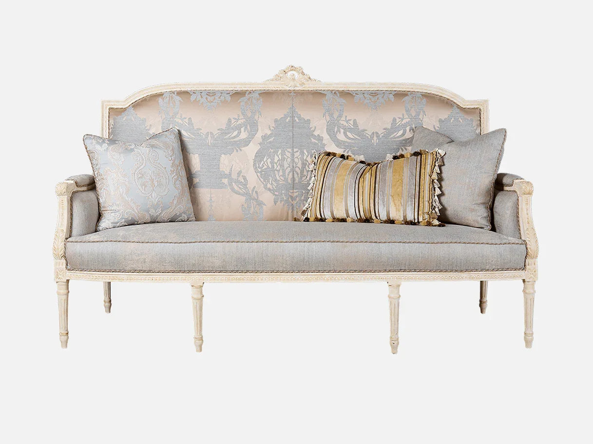 Front view of French sofa S-1208 in soft neutral jacquard with carved beech wood frame, antique lacquer finish, and accent pillows.