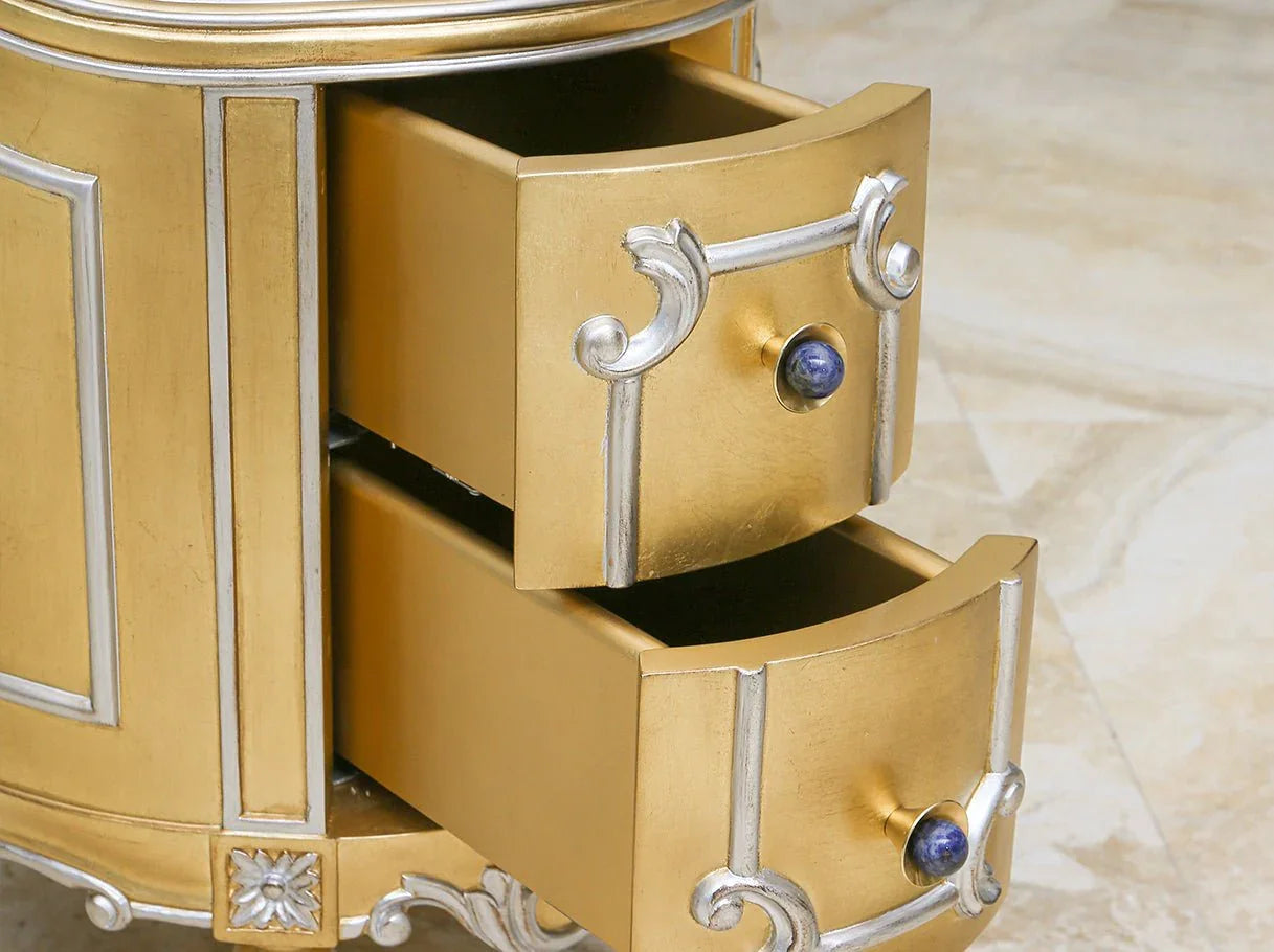 Close-up of two functional drawers on gold bedside table with decorative handles