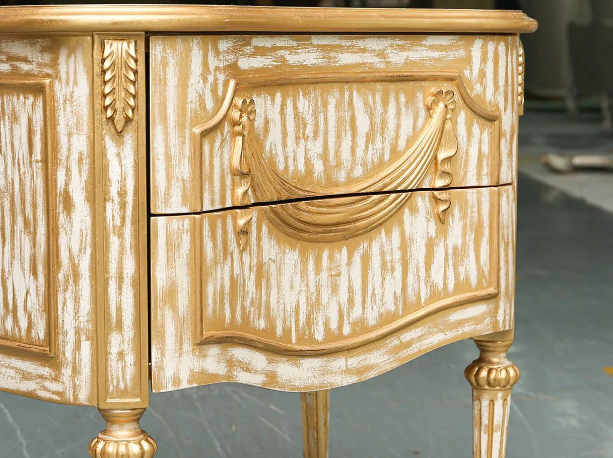 Close-up of antique inspired solid wood nightstand with gold accents