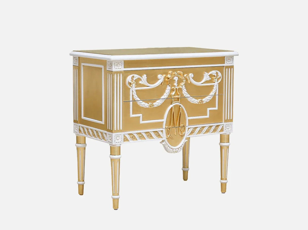 Side view of French vintage bedside table with white and gold accents