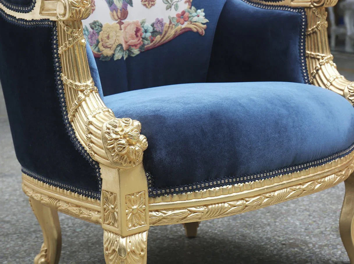 Close-up of carved armrest detail of French armchair A-0020 with gold leaf and floral motif.