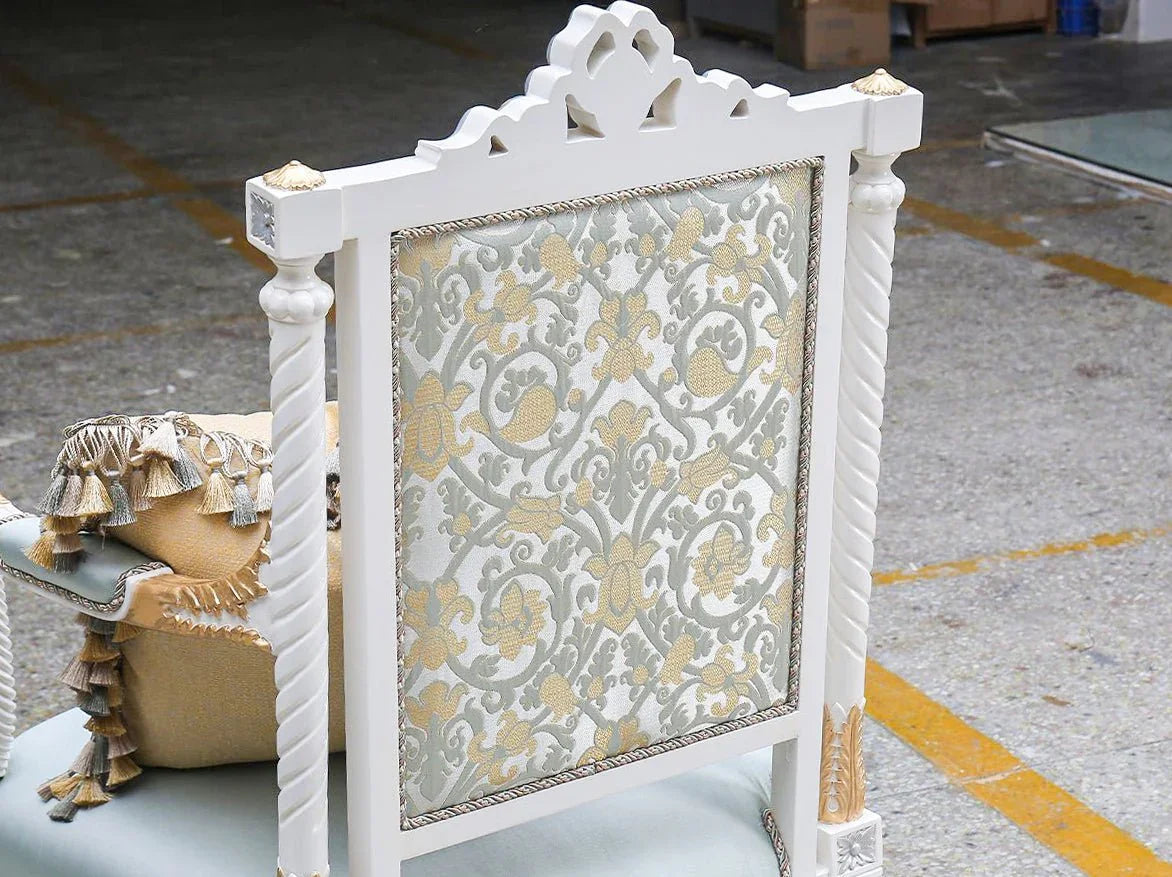 Back panel detail of French armchair A-0020 showcasing gold-accented carvings and intricate floral damask jacquard pattern.