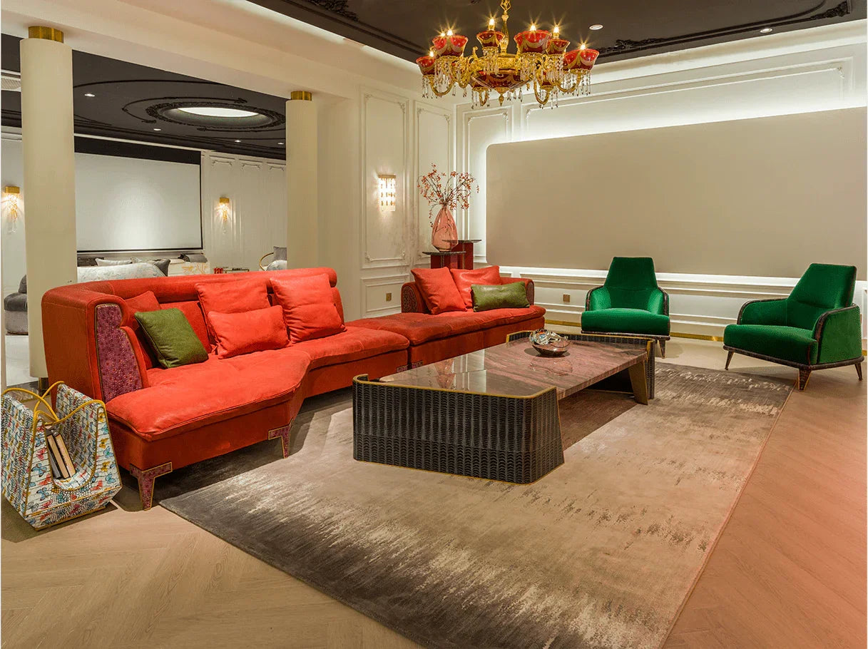 Large luxury sectional sofa in vibrant red leather, paired with green accent chairs – high end furniture