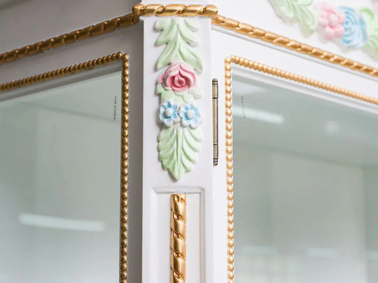 Liquor cabinet C-454 carving detail: Close-up of hand-carved motifs with gold leaf inlay .