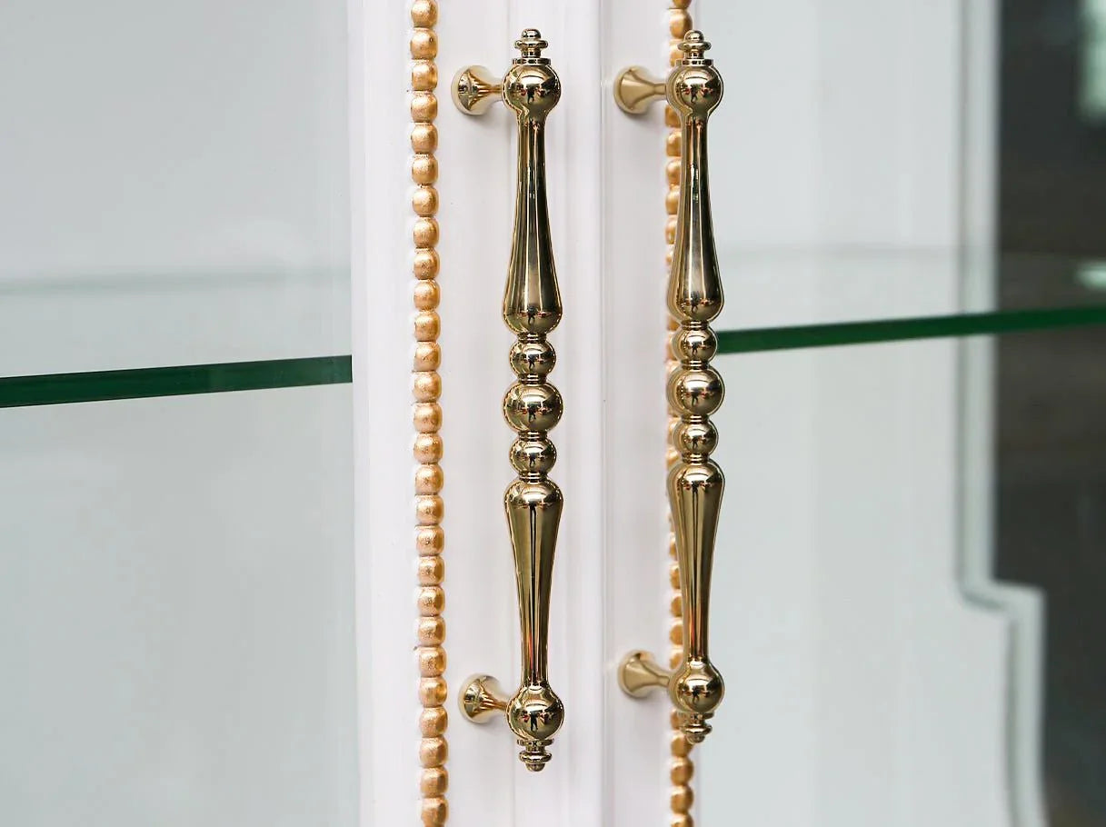 Liquor cabinet C-454 handle detail: Polished gold hardware, paired with carved wood and gold leaf.