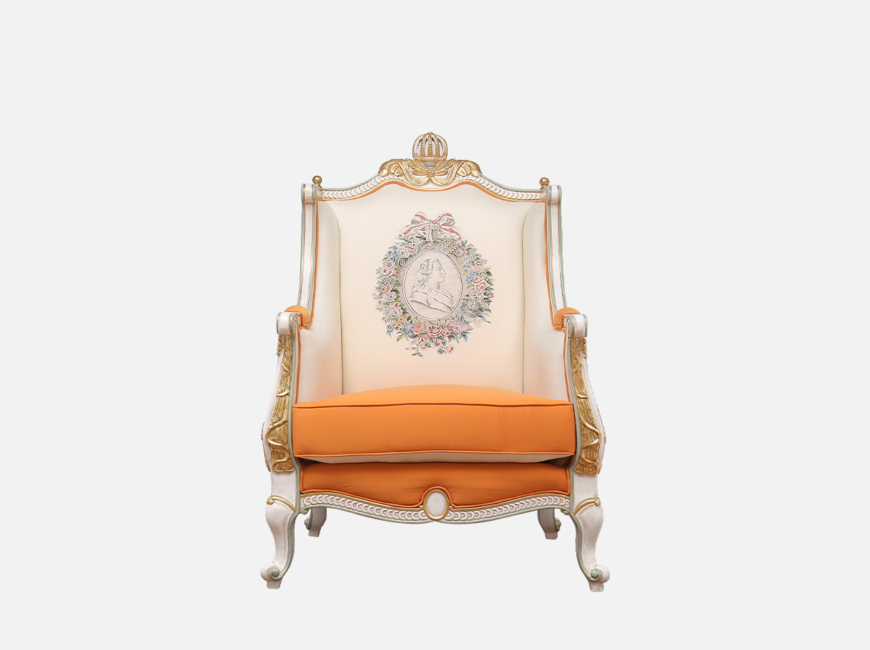 Front view of A-1183 orange armchair highlighting its ornate silhouette, gold leaf crown headrest, and floral details