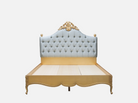 Front view of B-099 leather bed frame showcasing its hand-carved frame, gold leaf accents, and tufted leather upholstery