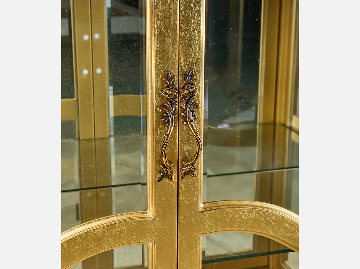 Close-up of C-033-1 cabinet handles — ornate metal detailing and gold leaf-finished wood